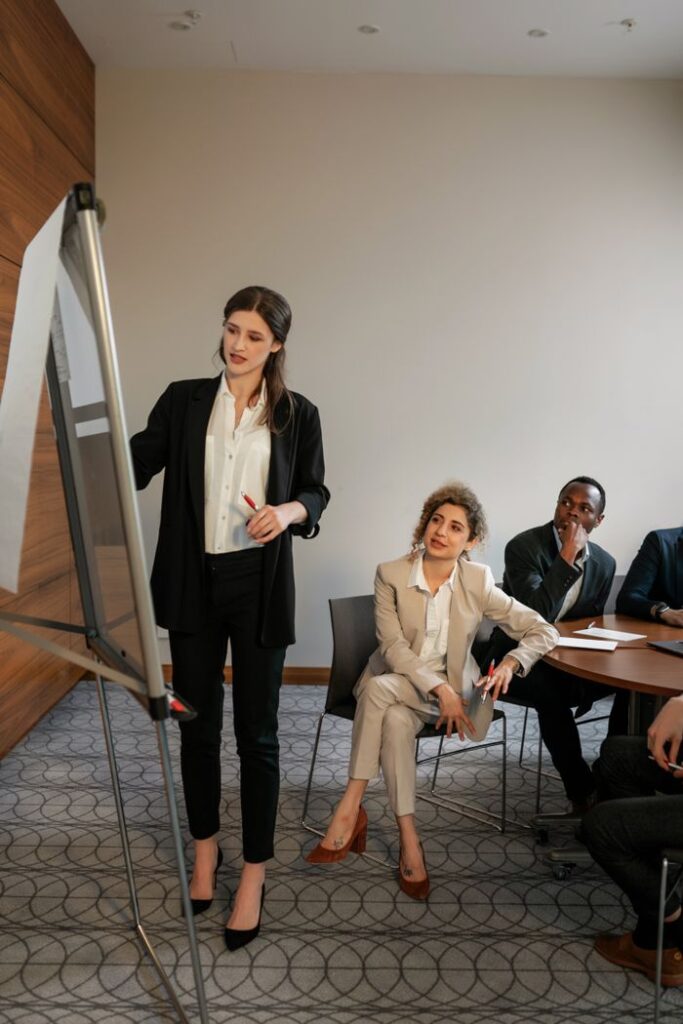 Business meeting with diverse team discussing strategies in a modern conference room.