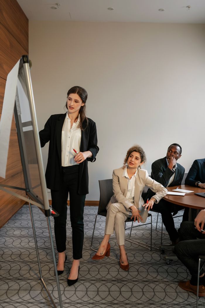 The Art of Drawing Readers In: Your attractive post title goes here Business meeting with diverse team discussing strategies in a modern conference room.